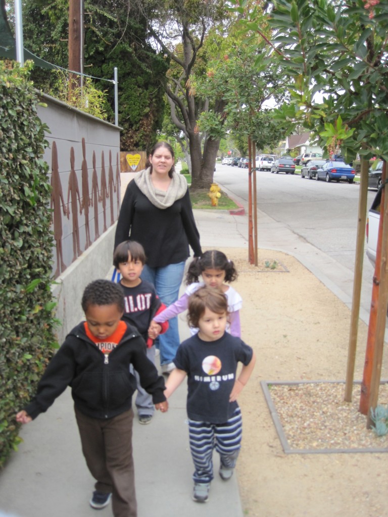 Sofia, Oliver, Xavier and Felix walk along May Street with Cassandra and Amy