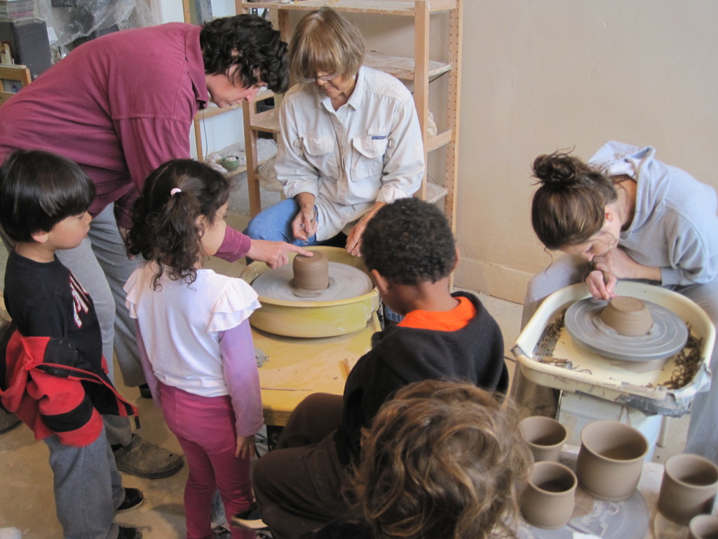 The children gathered around Linda's students to watch them work.